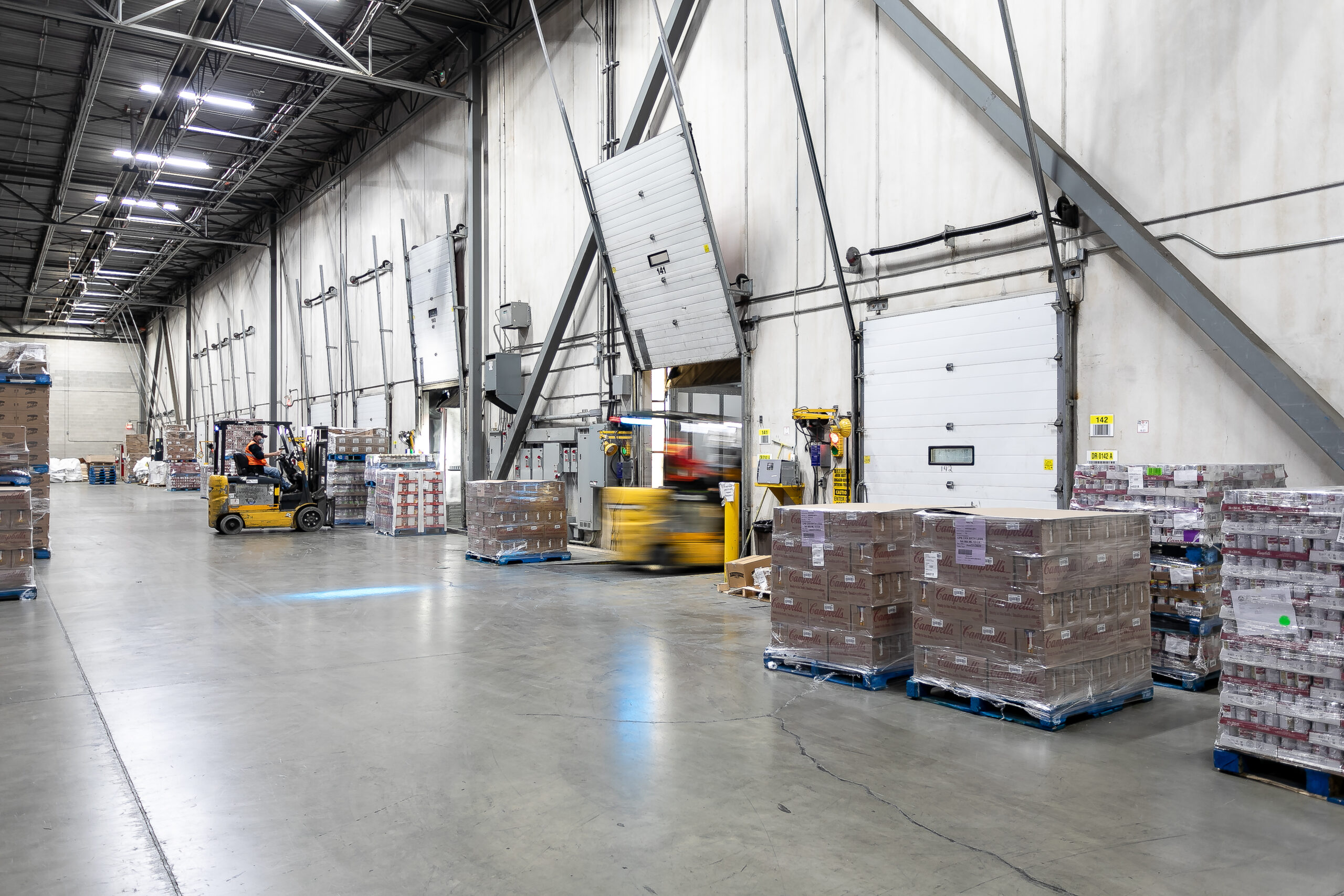 Pallets, waiting in a warehouse, to be loaded into a truck.