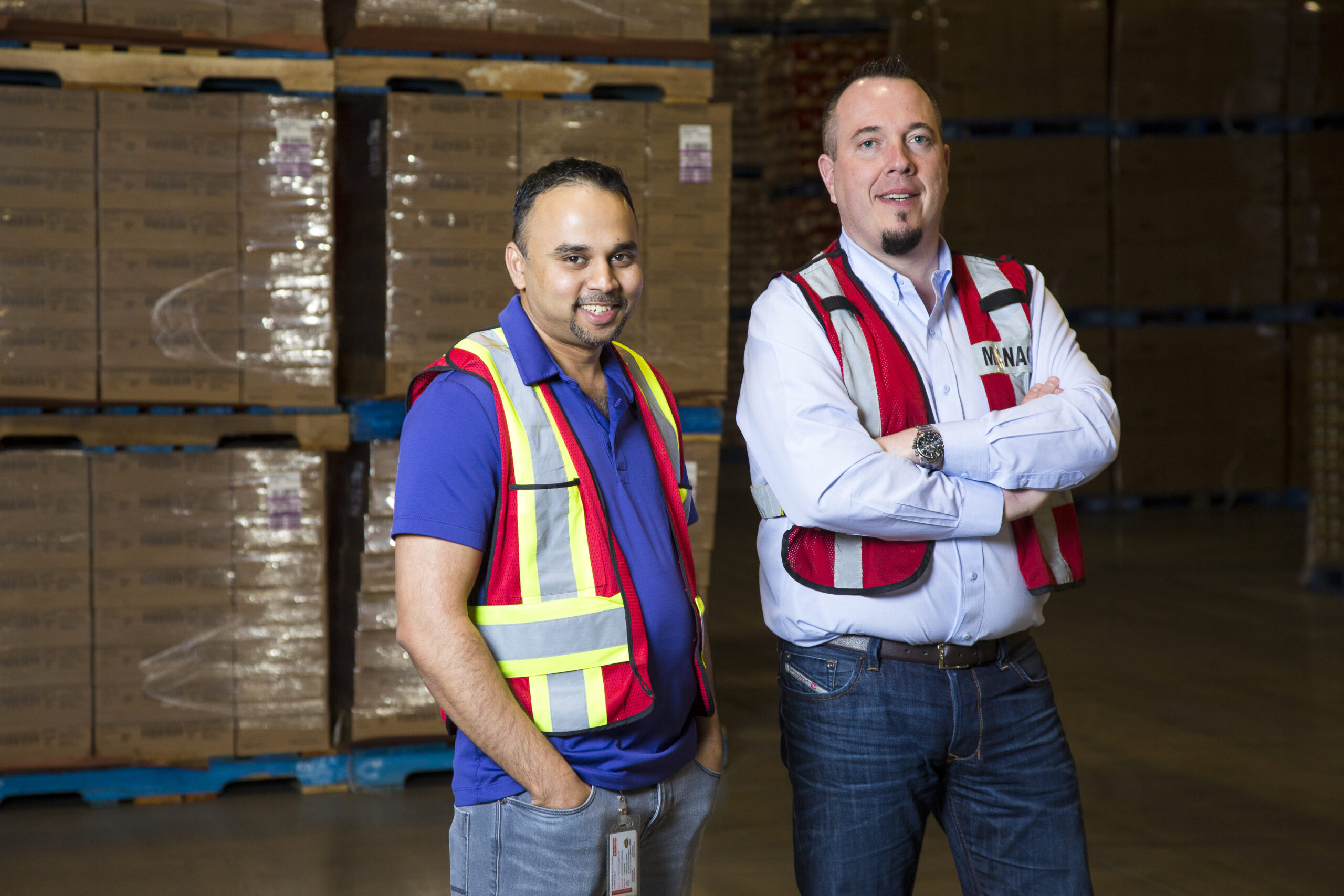 Team members standing together in a warehouse.